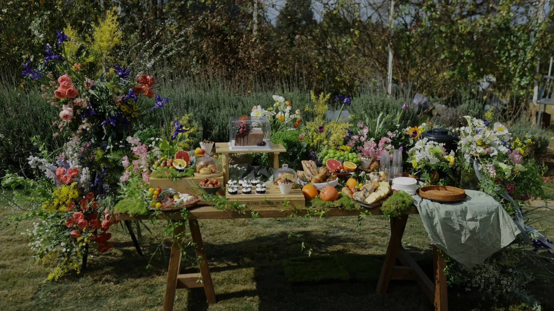 This image captures the essence of spring. Through a thoughtfully styled outdoor table surrounded by blooming flowers and fresh ingredients, it illustrates how gatherings during this time of year can feel both elevated and natural. The purpose is to inspire readers to embrace seasonal hosting—bringing people together in open-air settings that celebrate color, freshness, and sensory experiences.